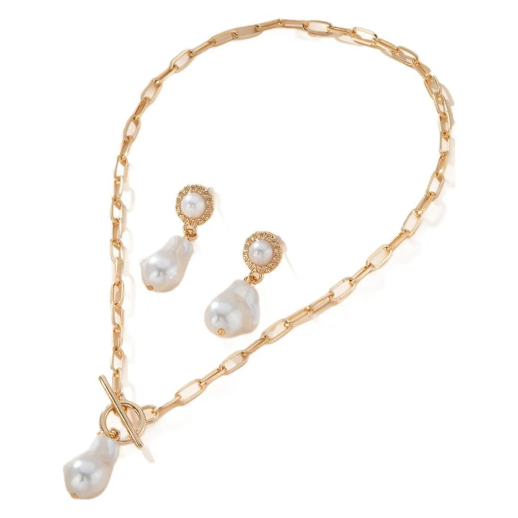 Gold-coloured retro baroque pearl necklace and matching ear studs set on a display.