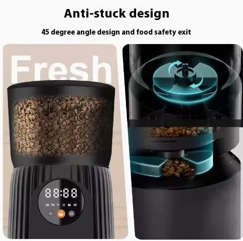 Black automatic pet feeder with digital display and food bowl on a kitchen counter.