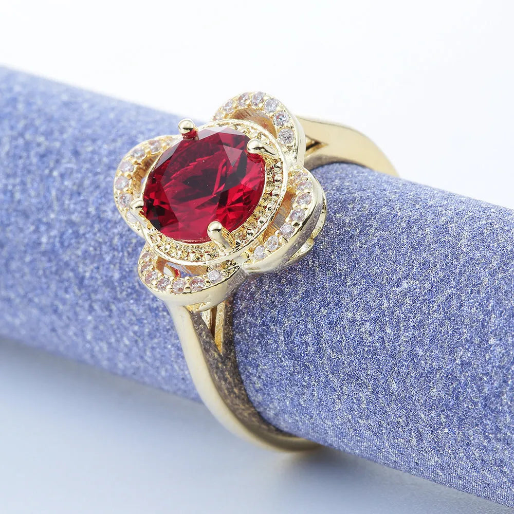 Copper fruit-shaped ring with inlaid zircon stones on a finger.