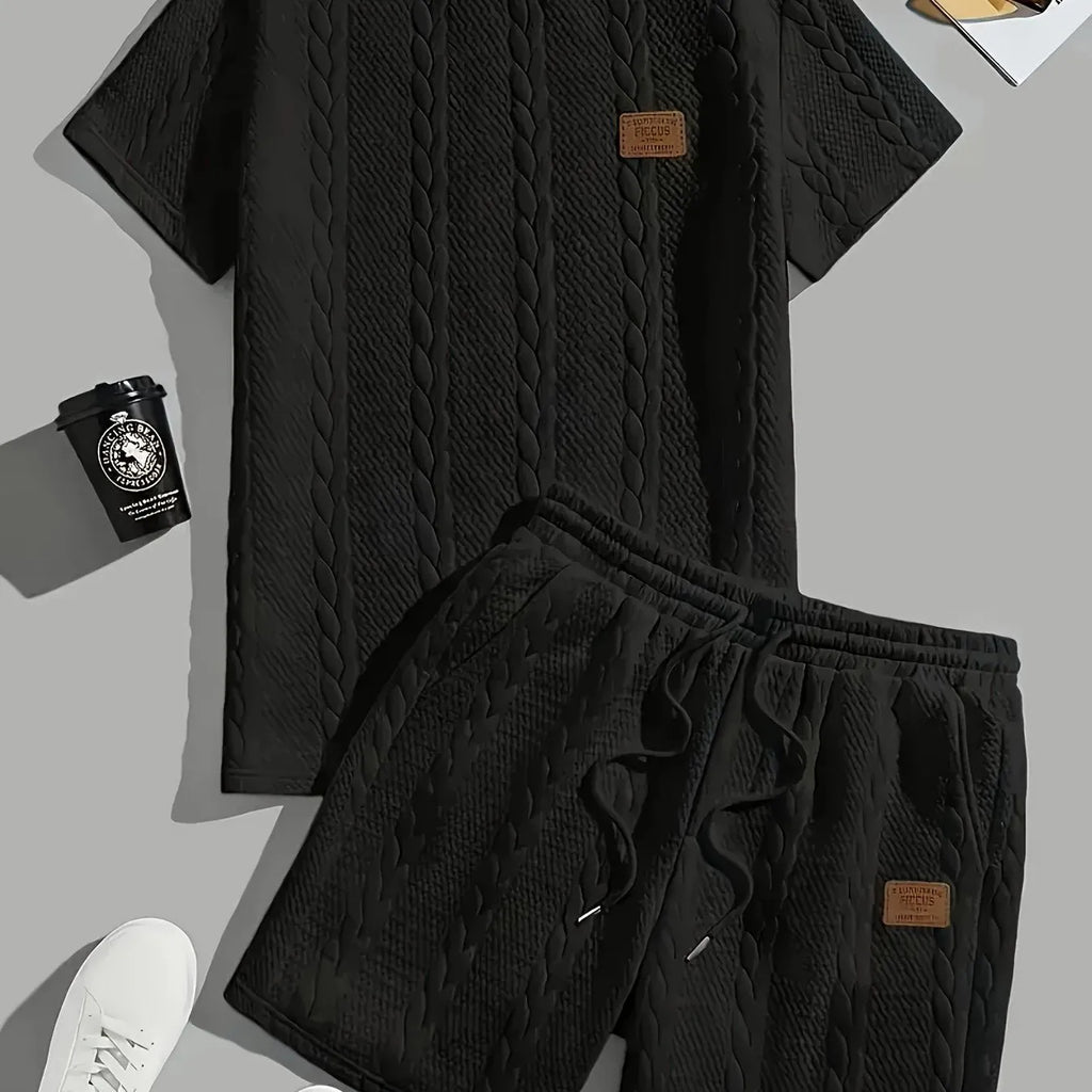Men's black sports two-piece set with ribbed short sleeve top and matching trousers for athletic activities
