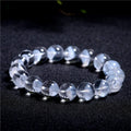 Women's natural white crystal bracelet with a pyramid charm and ruyi charm, showing spherical beads.