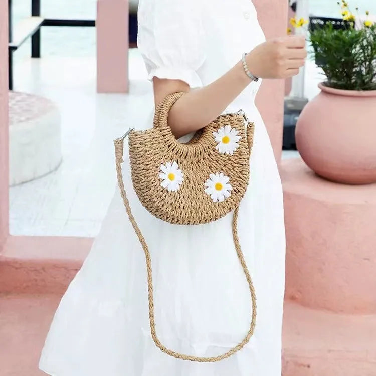 Women's woven straw crossbody bag with daisy pattern in light brown colour