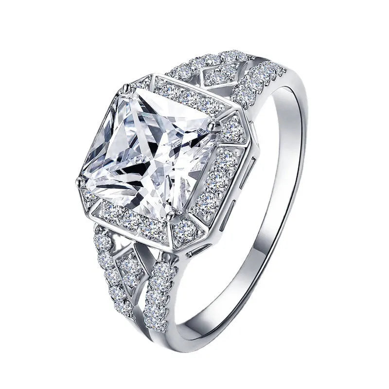 Platinum-colour hollow geometric ring with an inlaid cubic zirconia stone, shown from the side.