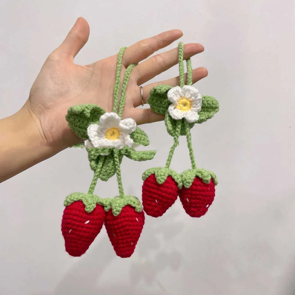 Handmade knitted strawberry-shaped car pendant made from cotton and hemp wool.