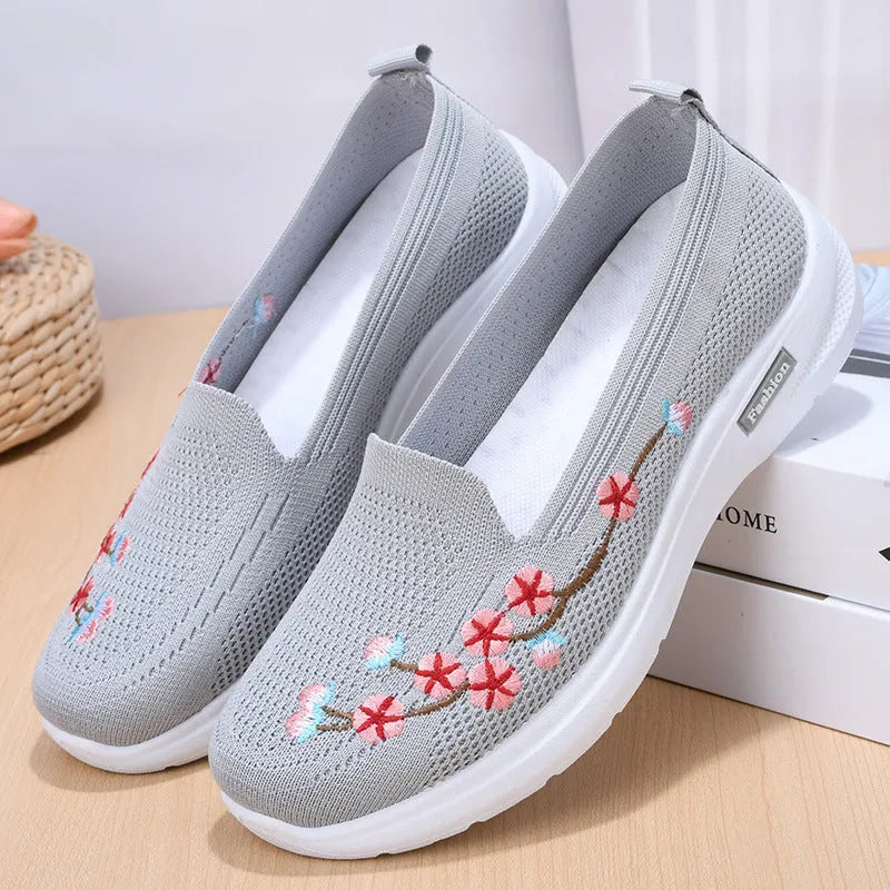 Women's wine red embroidered low heel pumps with round toe and anti-slip sole.