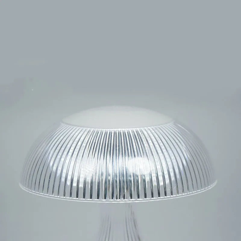Small white rechargeable night lamp with USB port and colour-changing LED light on a table.