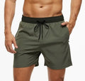 Men's blue training shorts with stitching waist detail, drawstring, and a zipped pocket on the leg.