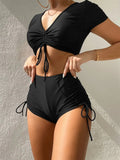 Women's dark green lace-up swimsuit top with matching shorts on a mannequin.