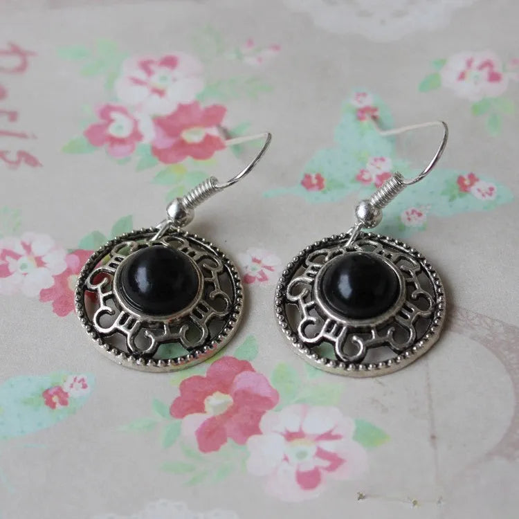 Handmade Miao silver ethnic earrings with turquoise on a retro flower disk design.