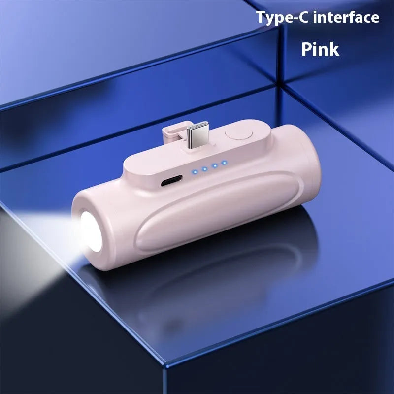 Black and pink creative power bank with built-in LED flashlight, showing Type-C and Apple port options.