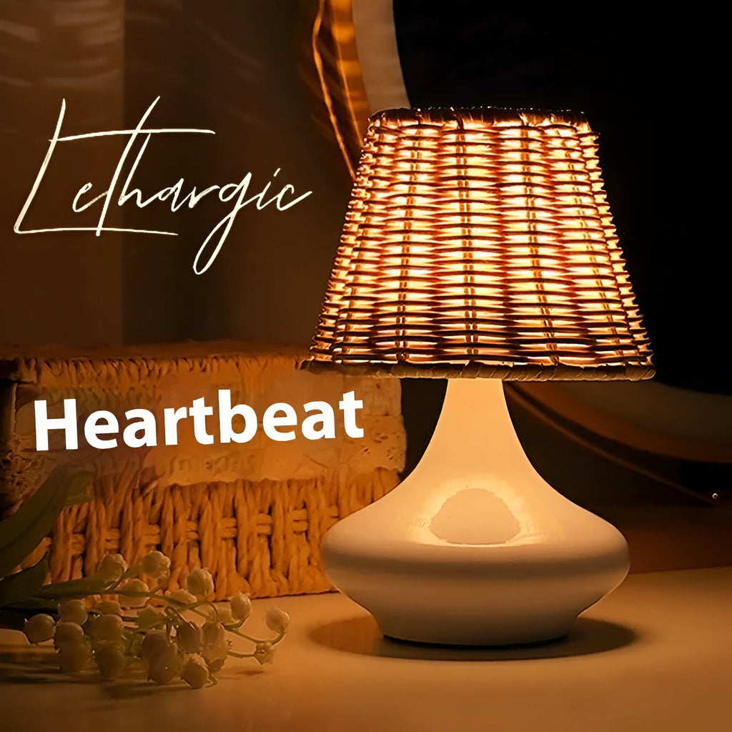 Bamboo desk lamp with black iron art base, USB cable, and warm light glow on a wooden table