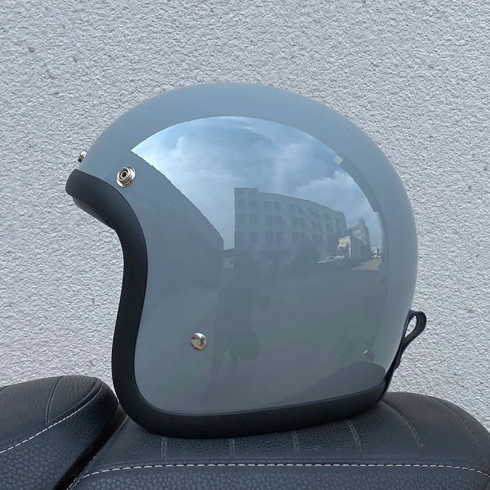 Cement Grey retro open-face motorcycle helmet with clear visor on a plain background.