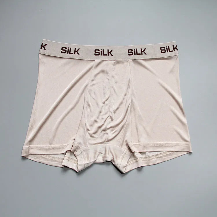 Men's loose fit silk shorts in navy blue, shown from the front on a mannequin.