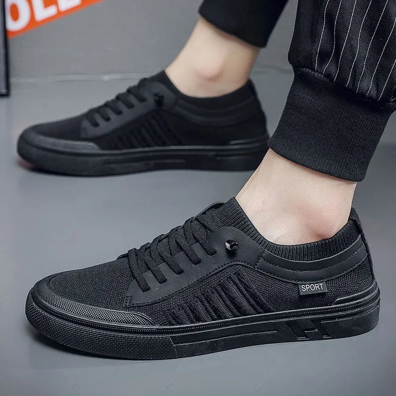 Men's low-top casual shoes in grey with mesh lining, flat plastic sole, and sewing thread detail