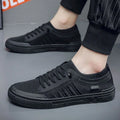 Men's low-top casual shoes in grey with mesh lining, flat plastic sole, and sewing thread detail