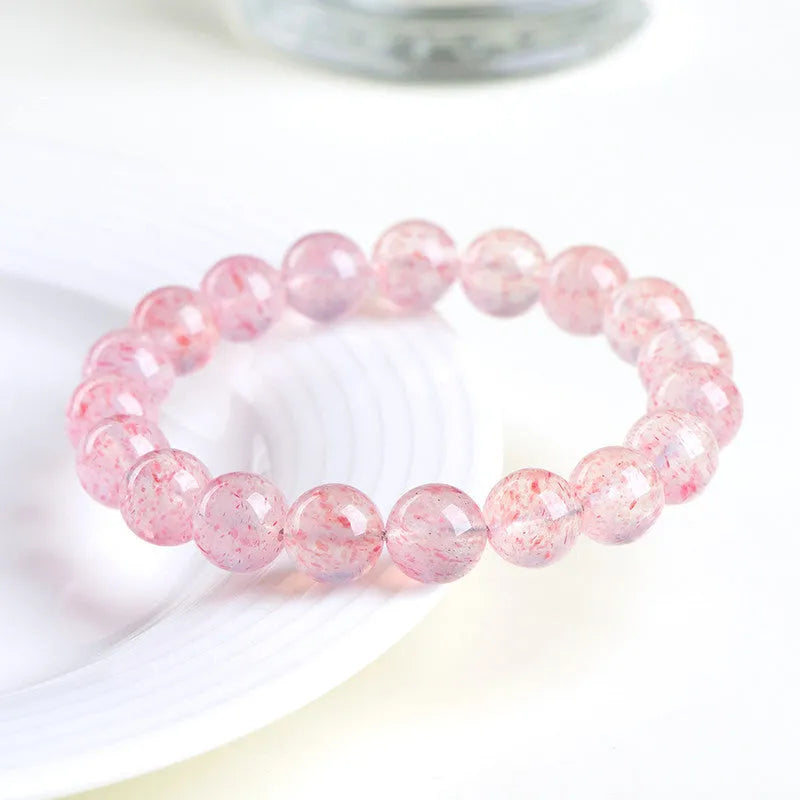 Natural white water strawberry quartz crystal ball bracelet with geometric beads.