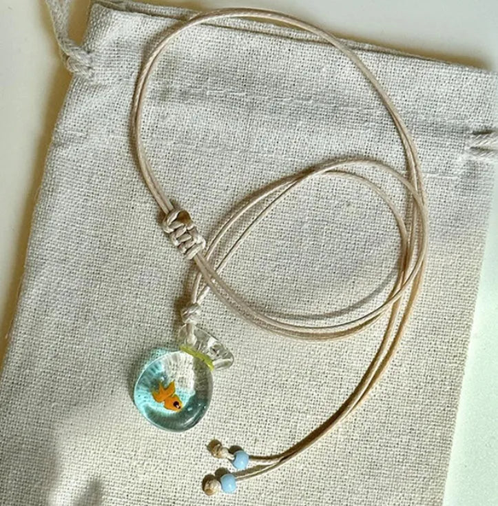 Women's coloured glaze pendant necklace on a beige cotton-linen cord, showing Skirt and Joker design details.