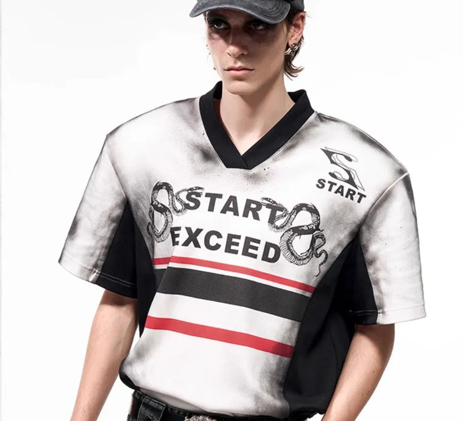 V-neck short sleeve top with snake letter pattern print and padded shoulders.
