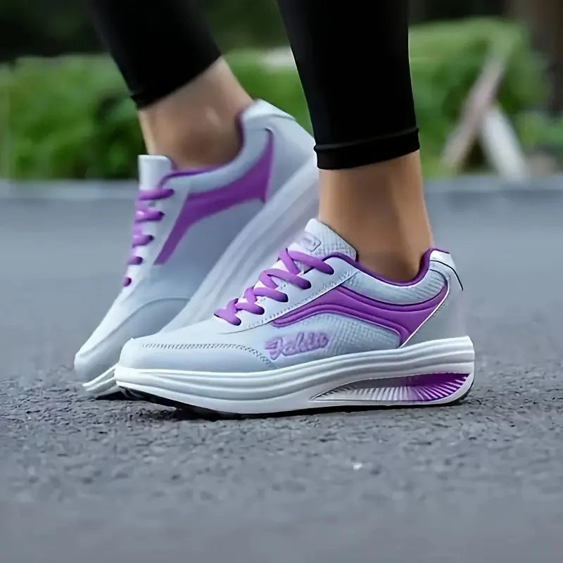 Women's grey powder heelless sports shoe with a mid-heel, shown on a neutral background.