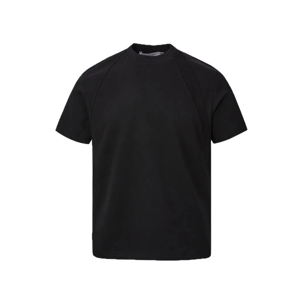 Man wearing a loose-fit grey short-sleeve top with textured air layer stitching detail.