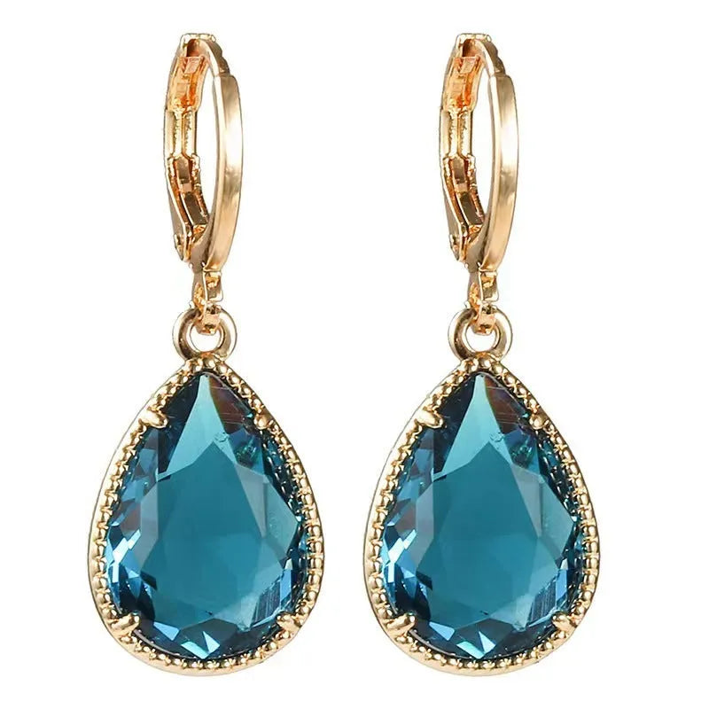 Copper-coloured rare earth metal and glass geometric saturn water drop earrings in multiple colours.