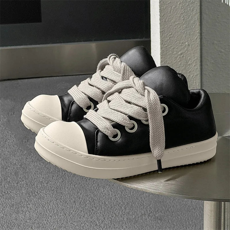 Men's black slip-on casual shoes with raised sole, leather uppers, and rubber soles showing round toe and shallow cut design