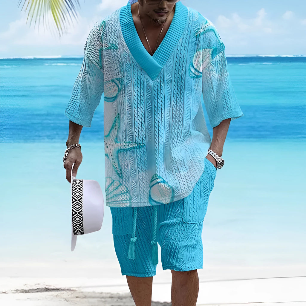 Man wearing a loose-fitting light blue short sleeve suit top and matching casual shorts.