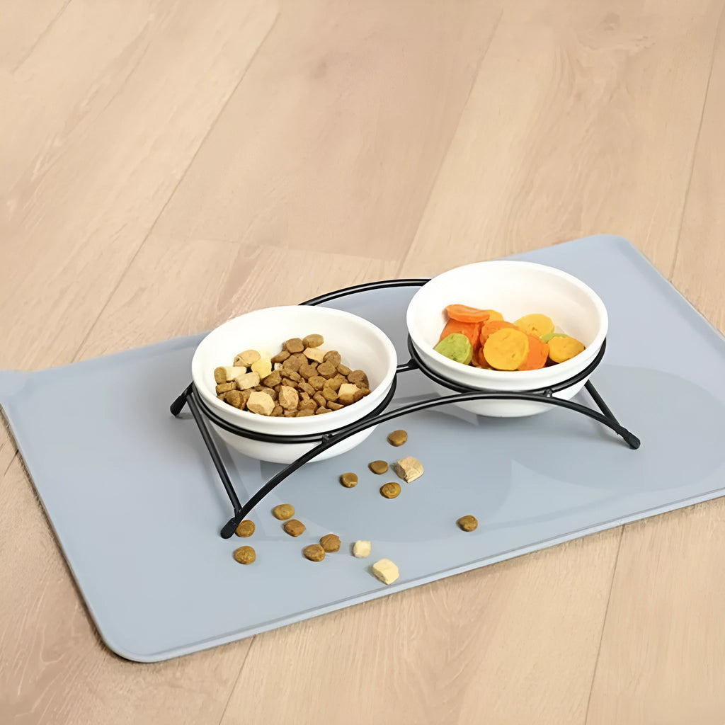 Silicone pet placemat in grey colour under a dog food bowl, showing raised edge.