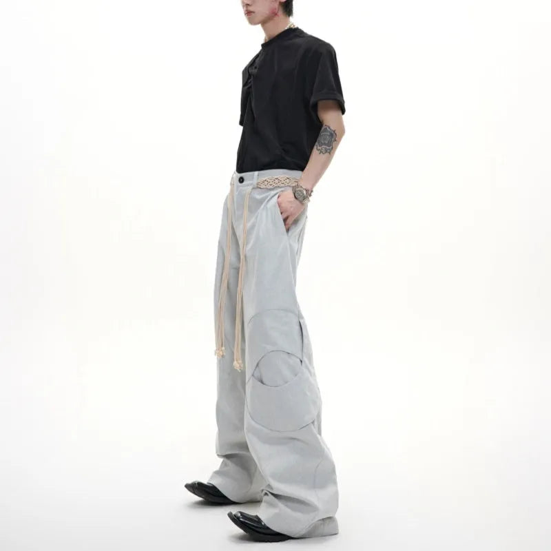Men's dark blue loose straight-leg trousers with heavy 3D stitching and zipper decorations.