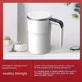 Black electric coffee mug with automatic magnetic stirring and LCD temperature display