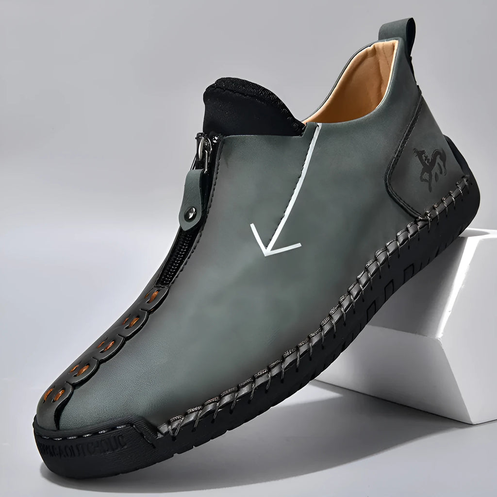 Men's black leather martin boots with a front zipper and round toe on a rubber sole.