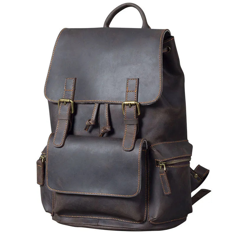 Brown leather backpack with double shoulder straps and denim lining interior