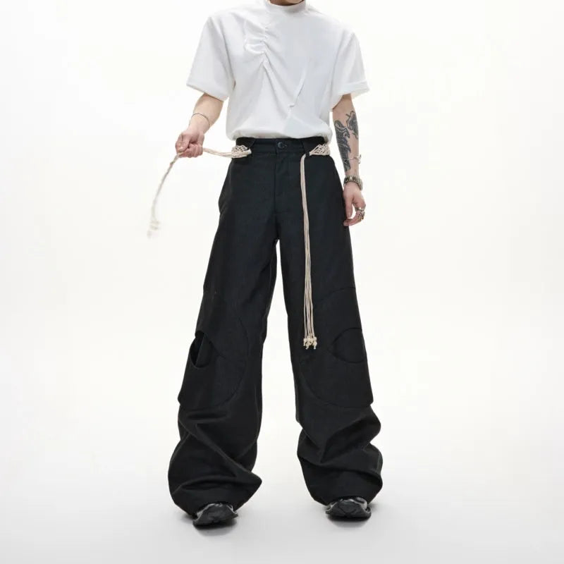 Men's dark blue loose straight-leg trousers with heavy 3D stitching and zipper decorations.