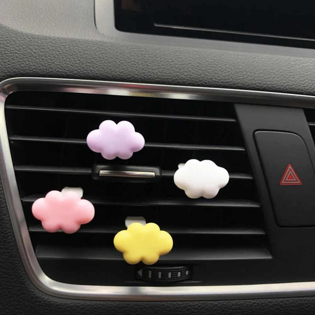 Colourful resin cartoon cloud car air freshener clip on a car vent.