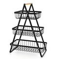 Black detachable double-layer iron fruit basket with wooden handle on tabletop