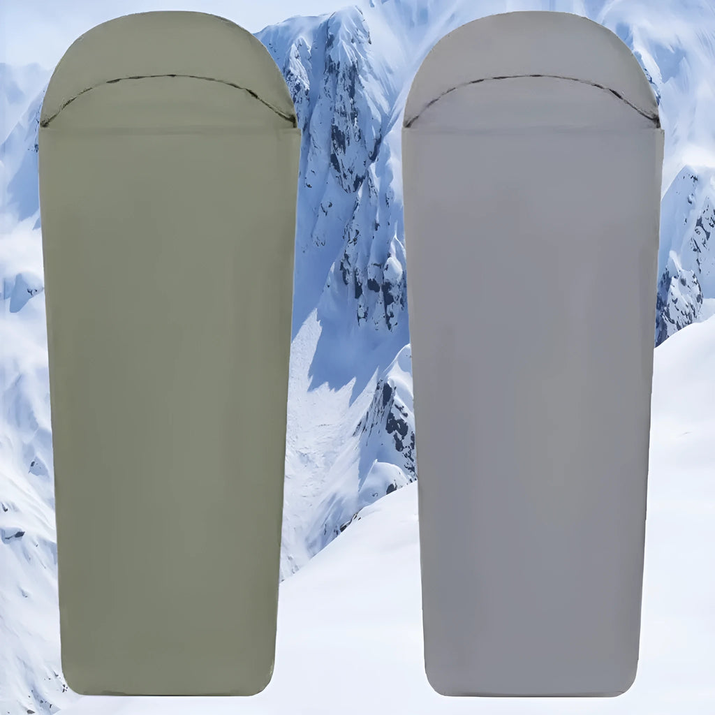 Blue mummy-style camping sleeping bag with tapered design on a green background.