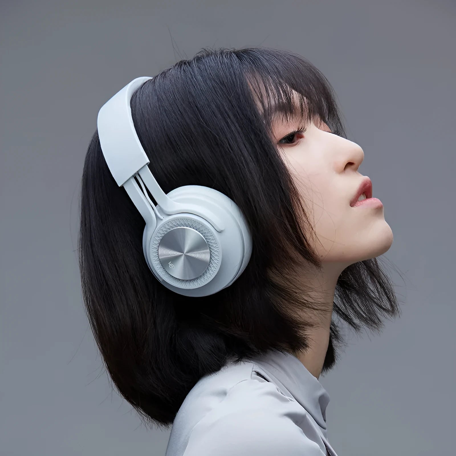 Sports wireless Bluetooth headset in black, green, grey, or red colours showing earpiece design.