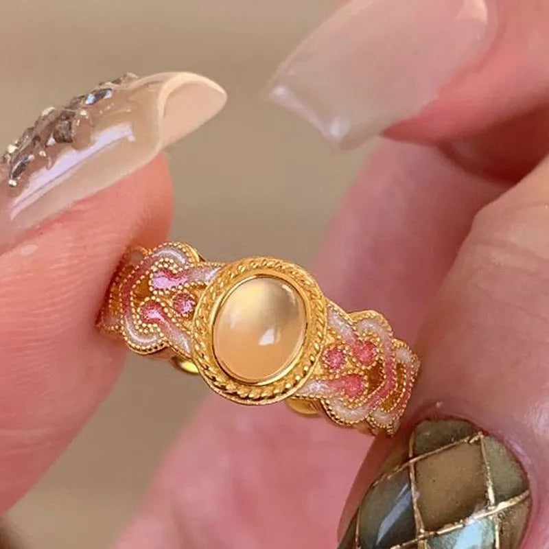 Geometric open mouth ring with pink crystal enamel detailing on copper gold plated band