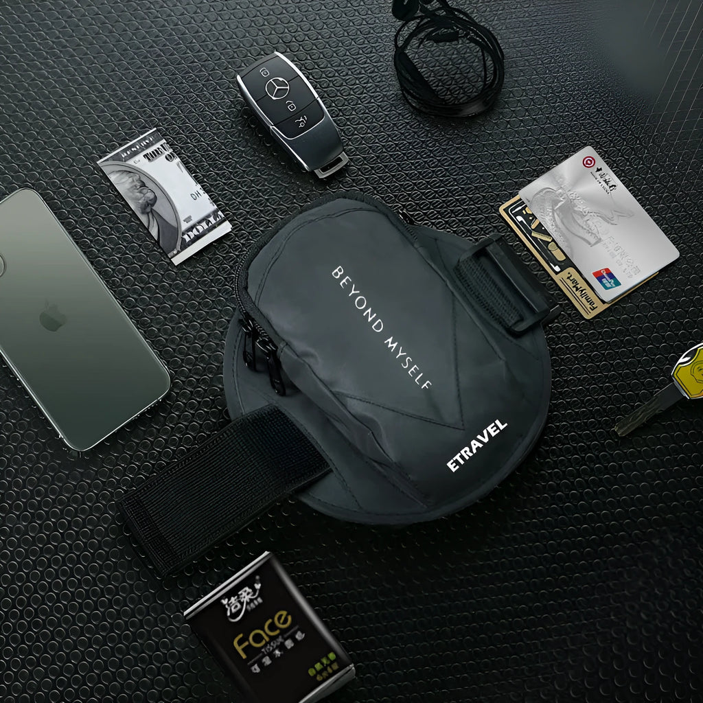 Black reflective running arm bag with adjustable strap, shown holding a smartphone, for outdoor sports safety.
