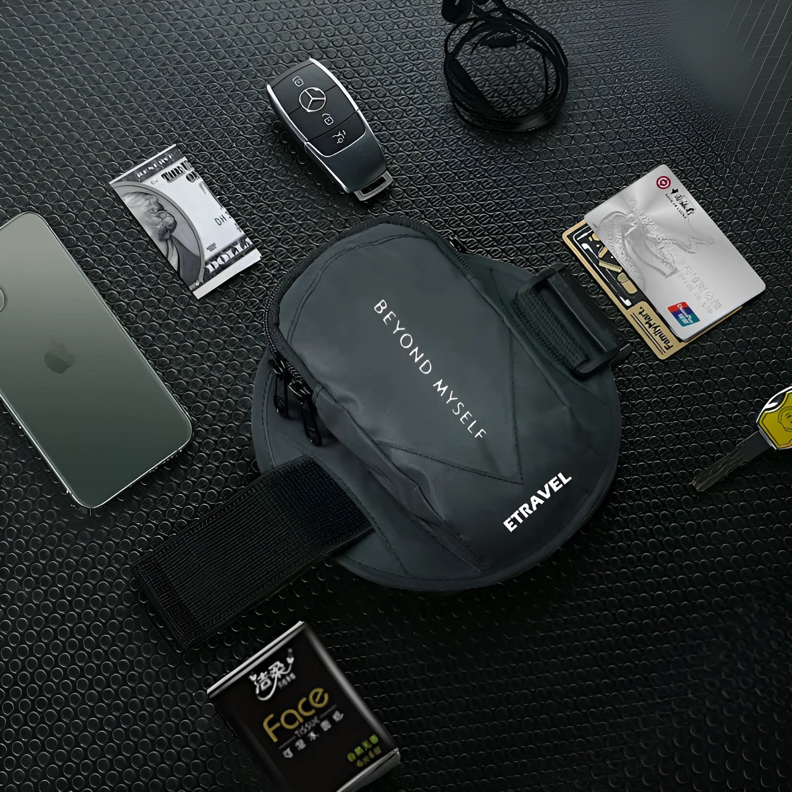 Black reflective running arm bag with adjustable strap, shown holding a smartphone, for outdoor sports safety.