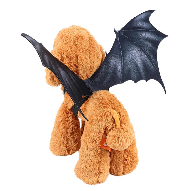 Black cloth bat wings costume accessory for a dog or cat on a Halloween background.