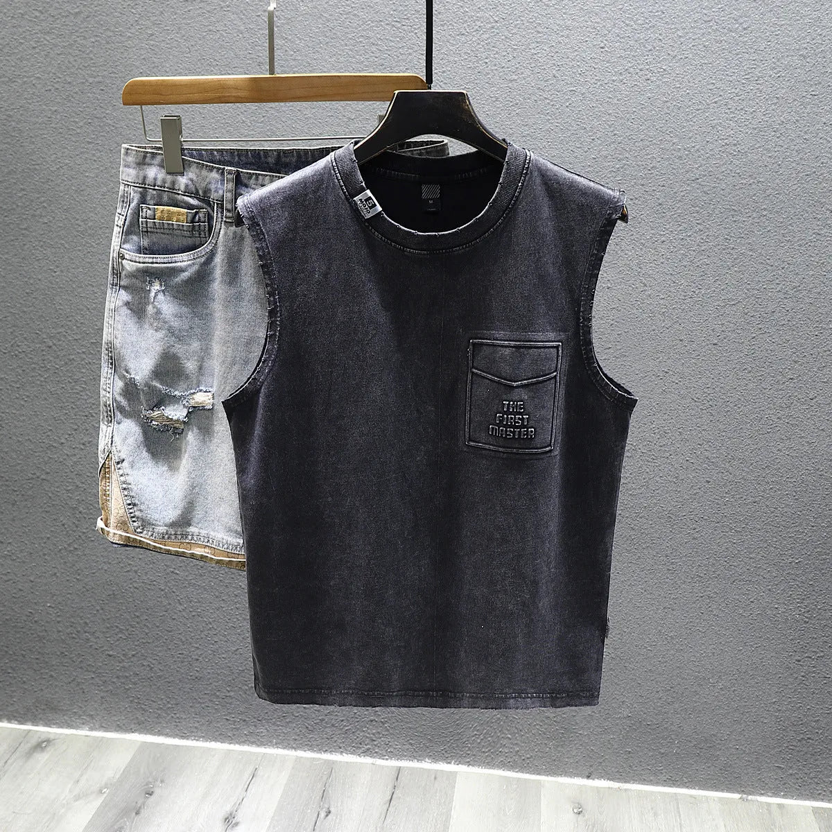 Women's loose fit cotton sleeveless vest in white on a hanger, showing straight hem and solid colour.