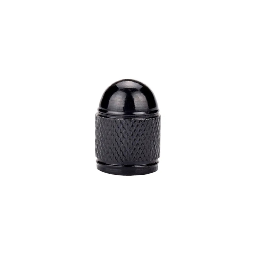 Aluminium alloy mountain bike tyre valve cap in assorted colours on a bicycle wheel.