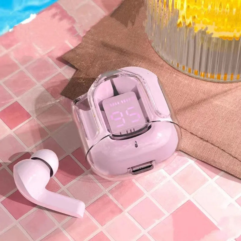 Transparent space capsule case containing true wireless Bluetooth earphones in various colours.