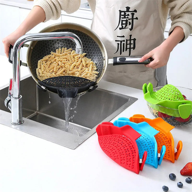 Green silicone pot drain stopper with stainless steel insert on a kitchen countertop.