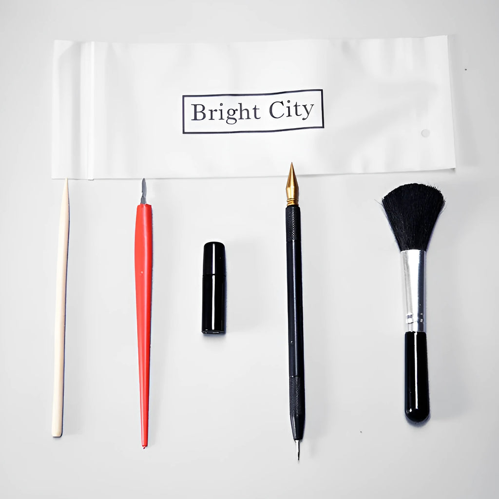 Scratch painting art tool set with healing pen, brushes, and scraper on white card paper.