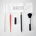 Scratch painting art tool set with healing pen, brushes, and scraper on white card paper.