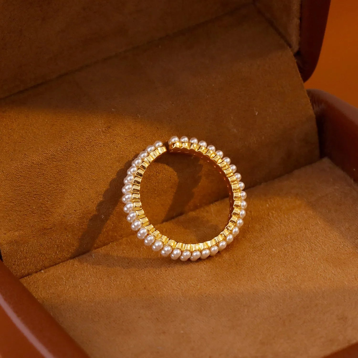 Geometric gold electroplated women's ring with open mouth design and round pearl element