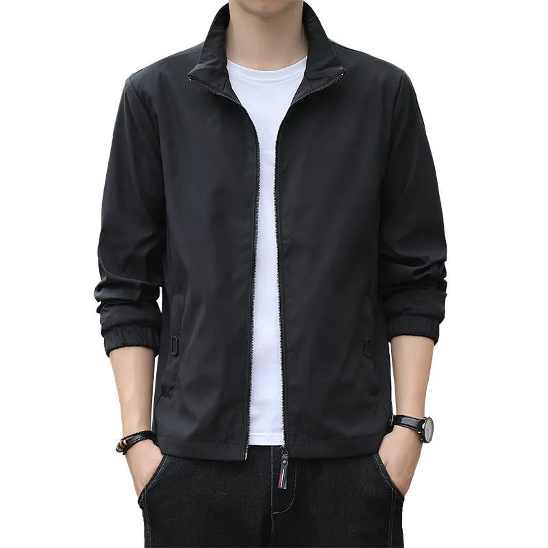 Man wearing a loose-fit grey Korean-style lapel jacket with zipper pockets.