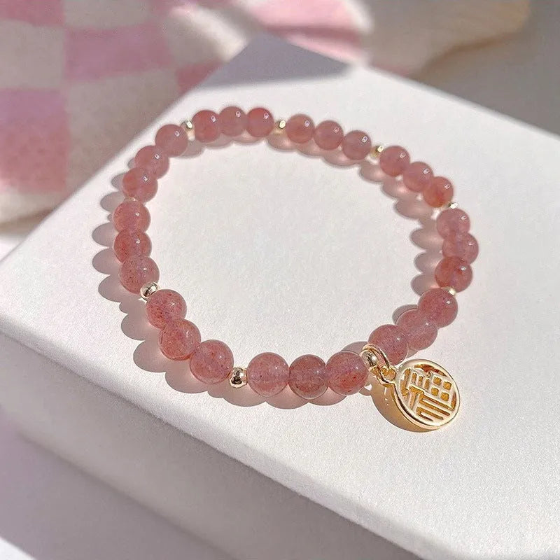 Handmade women's glass bracelet with strawberry quartz beads and blessing card